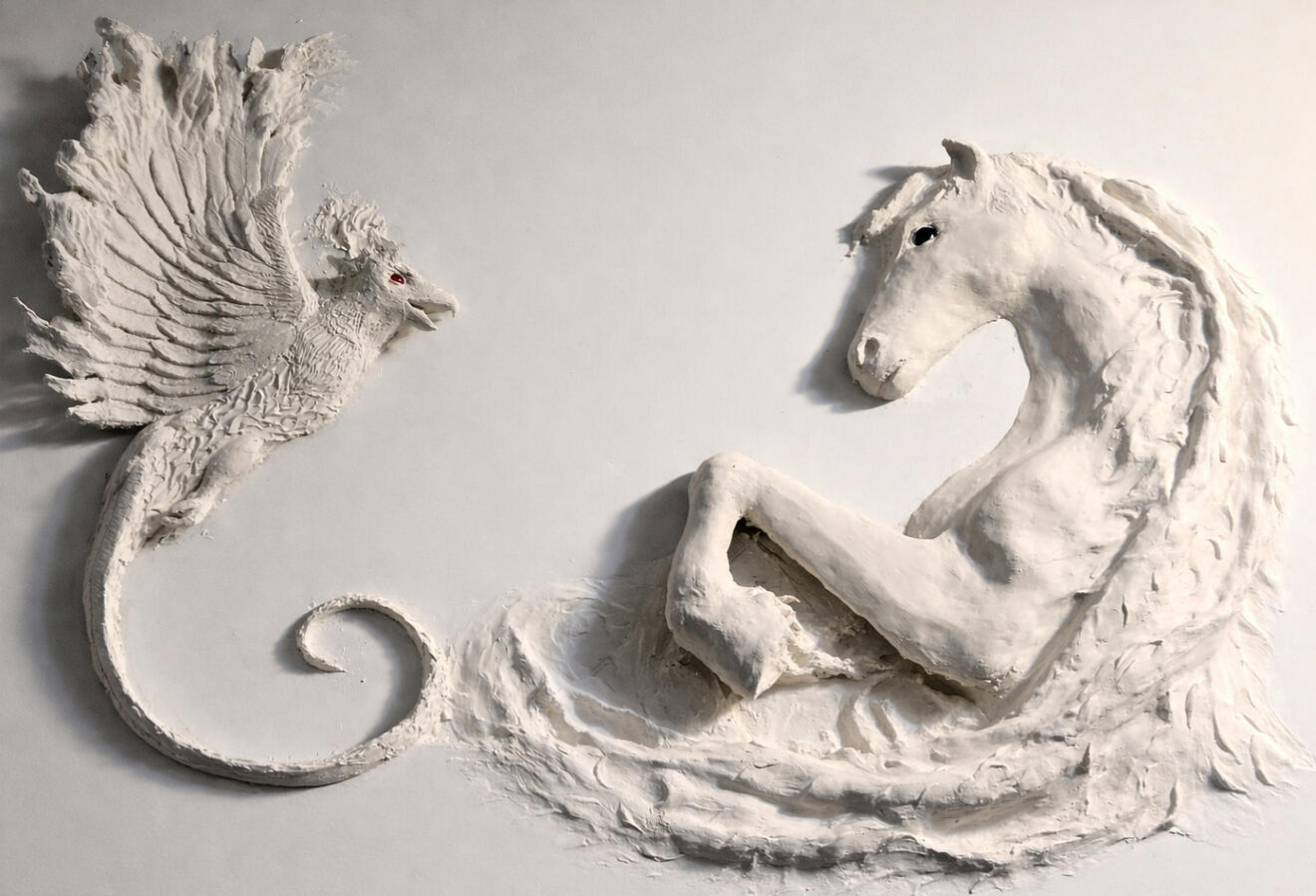 CINDER & SALT (2026) A phoenix and kelpie meet in a sweeping bas-relief, embodying the tension and harmony between fire, water, rebirth, and untamed spirit. Plaster (155 cm x 75 cm x15 cm)