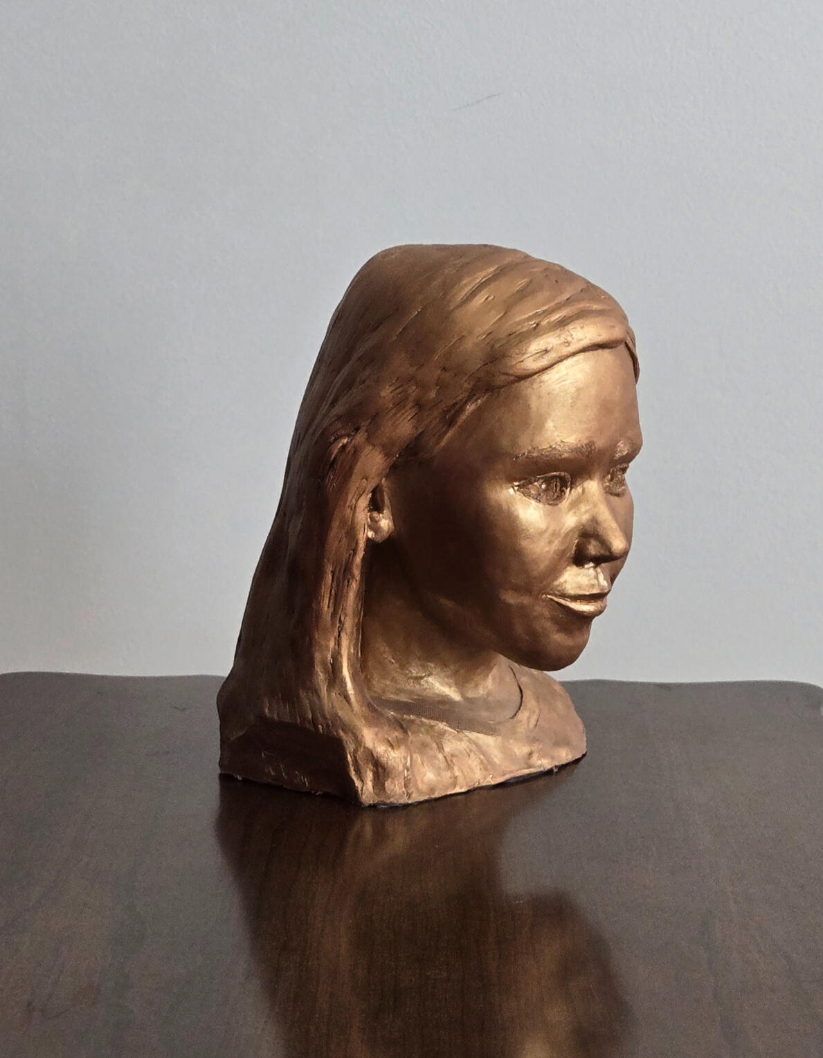 Life sized portrait study focused on softness of form, quiet expression, and the subtle balance between realism and presence. Oil-based clay, bronze resin cold cast. (31 cm x 21 cm x 16 cm)