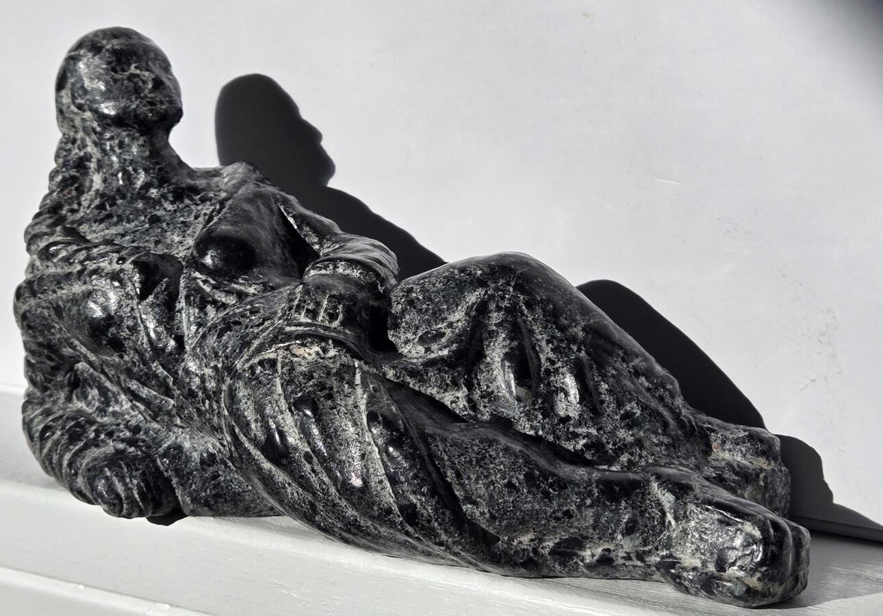 ENN ZHENN FAAM (2025) – Figure of a young Métis woman incorporating traditional sash and capote. Soapstone. (10 cm x 16 cm x 6 cm)